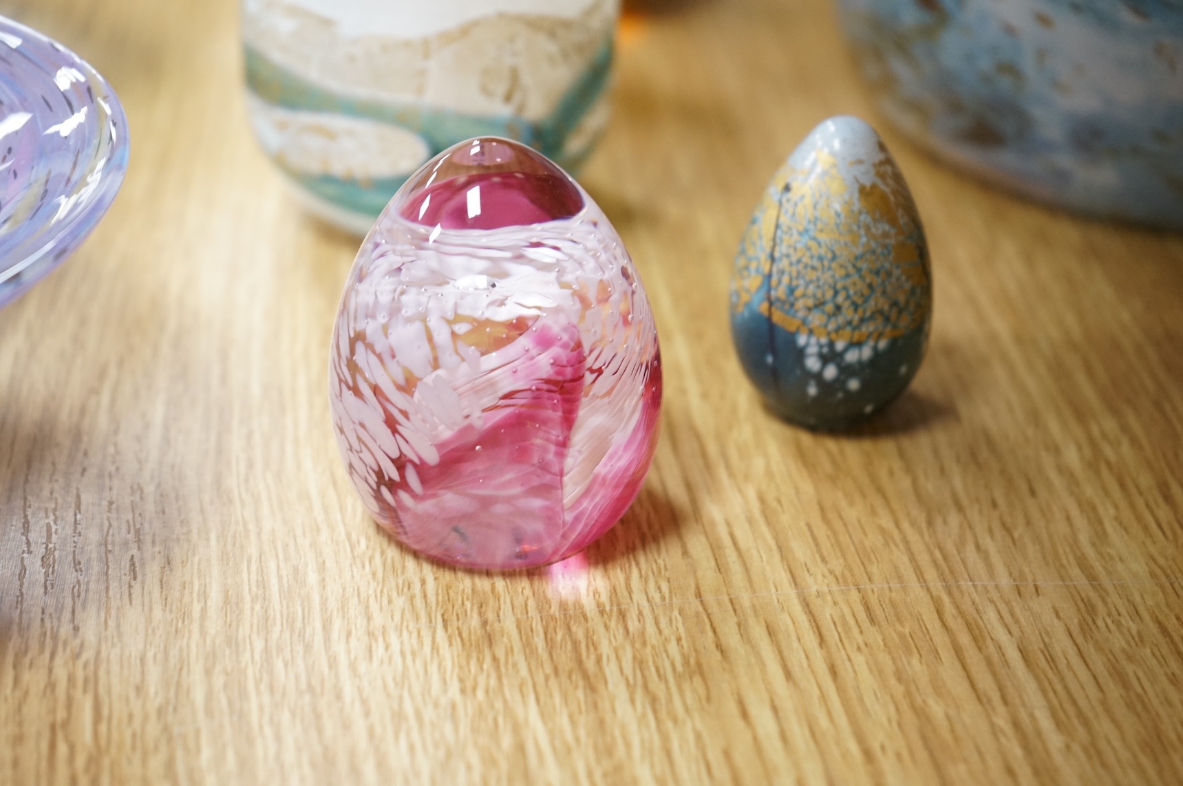 A collection of mixed art glass and paperweights, including two Mdina flared rimmed glass vases, Adrian Shankey glass, an Isle of Wight squat vase, various paperweights and a dump etc. (15)